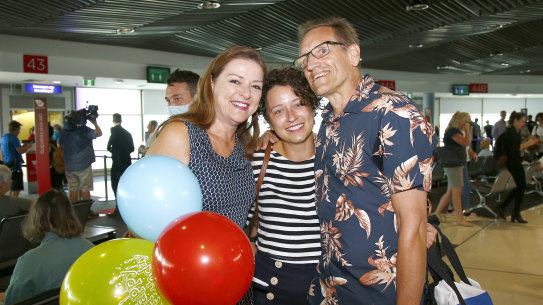 Crowds have returned to Brisbane Airport since it reopened in December 2020. Here Graham and Natalie Auchterlonie welcome daughter Katherine. when Brisbane Airport reopened in December 2020. 