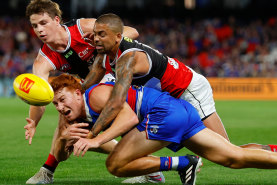 Mattaes Phillipou and Brad Hill exemplify St Kilda’s intensity with a gang-tackle on Ed Richards.