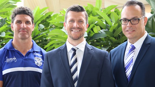 New Canterbury Bulldogs chief executive Aaron Warburton (middle) with coach Trent Barrett (left) and club chairman John Khoury.