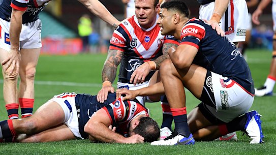 Roosters players show their concern for Boyd Cordner after the skipper went down against the Knights.