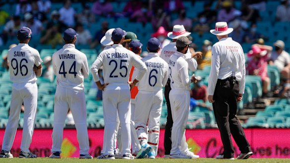 Paul Reiffel and Paul Wilson speak to the Indian players before tea.