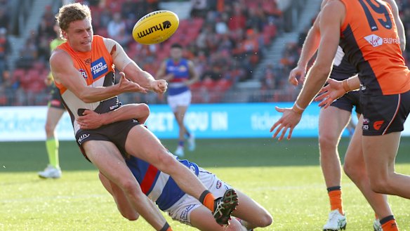  Bulldog spirit: Giant Adam Kennedy can't escape the clutches of Will Hayes.