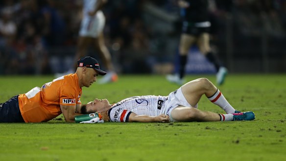 Down and out: Luke Keary receives attention after suffering a concussion. 