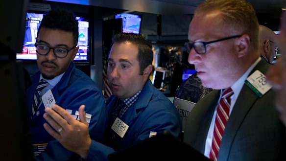 Traders on the floor of the New York Stock Exchange on Monday. China's drastic retaliation in the trade war has sent financial markets reeling.