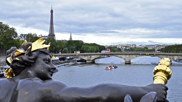 A boat pulls out of the starting line in front of the Eiffel Tower after the cancellation of the Open Water Swimming World Cup on August 6.