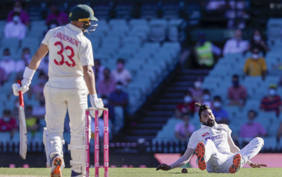 Mohammed Siraj falls as he fields the ball hit by Australia's Marnus Labuschagne at the SCG.
