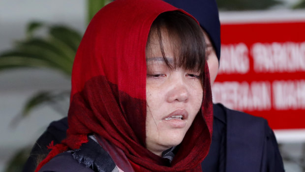 Vietnamese Doan Thi Huong is escorted by police as she leaves Shah Alam High Court in Shah Alam, Malaysia.