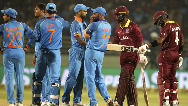 West Indies batsmen Shai Hope (far right) and Kemar Roach react after the tie against India.