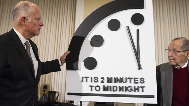 Former California governor Jerry Brown, left, and former secretary of defence William Perry unveil the Doomsday Clock during the Bulletin of the Atomic Scientists news conference in Washington on Thursday.