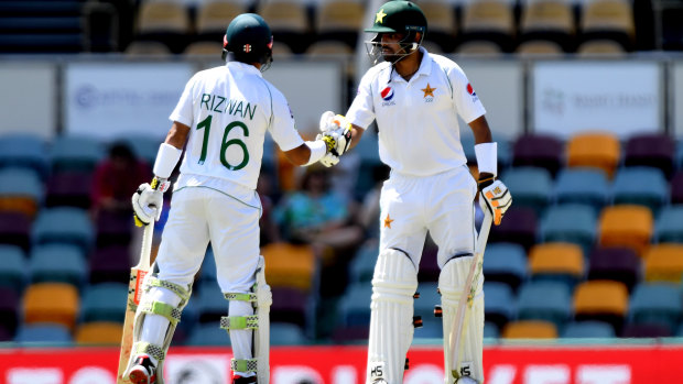 Small mercies: Babar Azam (right) and Muhammad Rizwan provided some much-needed fight for the tourists in a first-Test drubbing at the Gabba.