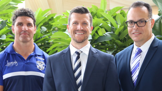New Canterbury Bulldogs chief executive Aaron Warburton (middle) with coach Trent Barrett (left) and club chairman John Khoury.