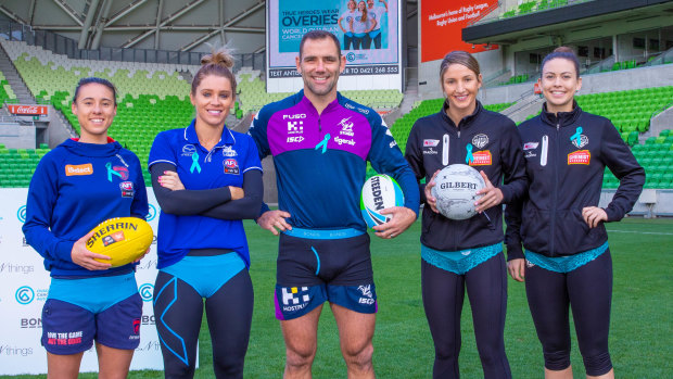 Cancer warriors: AFLW players Aliesha Newman (Melbourne) and Sophie Abbatangelo (North Melbourne) with Storm skipper and Ovarian Cancer Australia ambassador Cameron Smith, and Collingwood Magpies netballers Kim Ravaillion and Gabby Sinclair.  