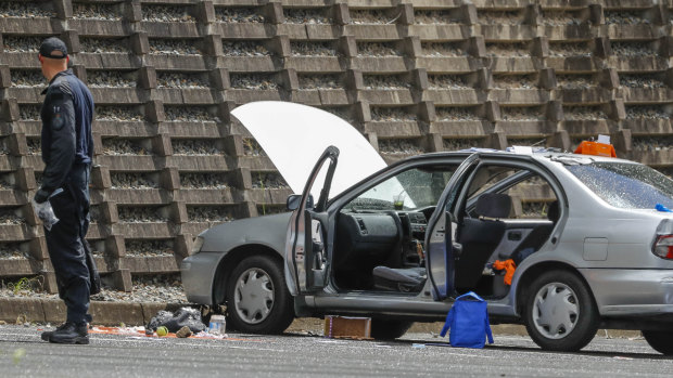 An Explosive Ordnance Response Team searches a car at Redbank Plaza car park.