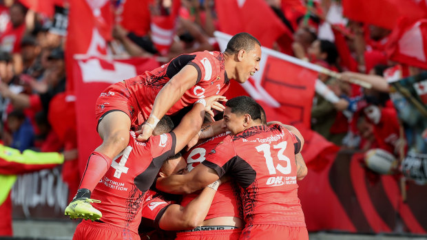 Happy days: Tonga celebrate a try against New Zealand at the World Cup last year.