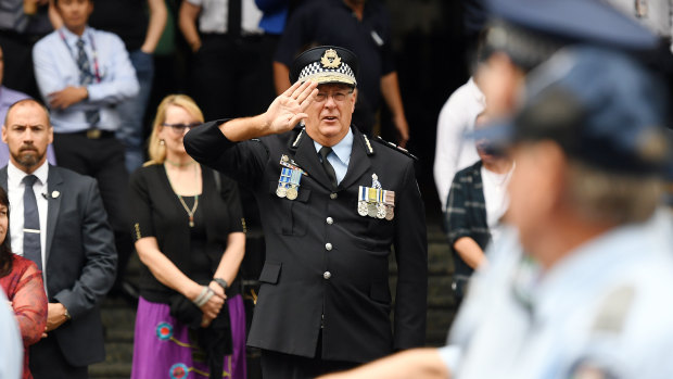 Queensland Police Commissioner Ian Stewart salutes members of the force marching in a National Police Remembrance Day parade in Brisbane.