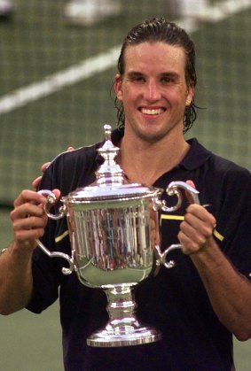 Patrick Rafter holds up his trophy after  winning the men’s singles finals match at the U.S.  Open.