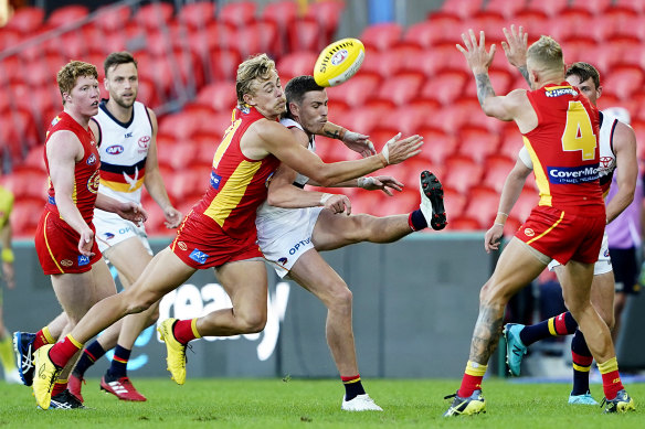 Greenwood tackling Rory Laird during the Suns win over the Crows, his former club, at Metricon Stadium on Sunday.