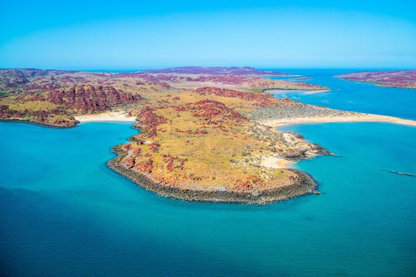 Mouthwash-blue coastline of the Dampier Archipelago, part of the Murujuga Cultural Landscape.