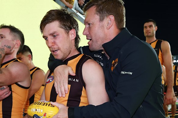 Dylan Moore and Hawks coach Sam Mitchell embrace post game.