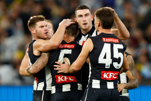 Collingwood players show their support for new teammate Dan McStay (facing camera) after a goal against Richmond. 