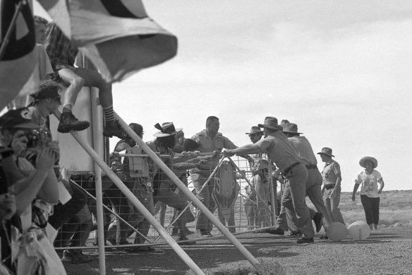 Protestors break through the gates at Nurrungar base.