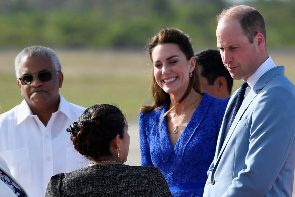 Catherine and Williamare greeted on their arrival in Belize City, Belize.