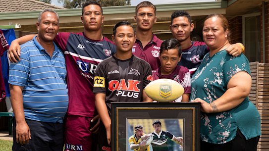 Legacy: Members of the Tupulua Fai household, from left, Tupulua, Zechariah, Zhaoquin,  Zhivargo, Sonny, Zedrick and Lyndah, with a framed photo of former Warriors star Sonny Fai (above).