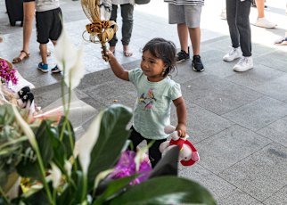 A young child lays flowers for the victims of the Christchurch massacre.