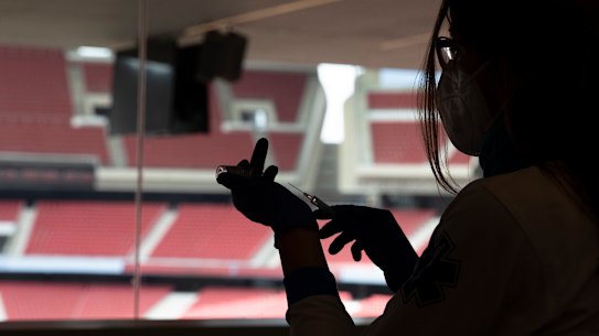 A health worker prepares a dose of the AstraZeneca vaccine mass vaccination at Wanda Metropolitan stadium in Madrid, Spain, on Thursday.