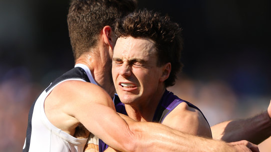 Jordan Clark is tackled by Carlton’s George Hewett during the Dockers’ loss to the Blues on Saturday.