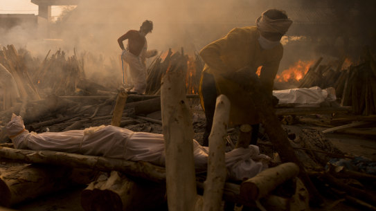 A priest prepares to perform the last rites of a patient who died of COVID-19 during a mass cremation at a crematorium on May 01, 2021 in New Delhi, India. 