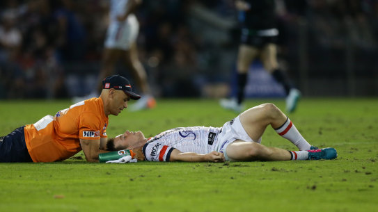Down and out: Luke Keary receives attention after suffering a concussion. 