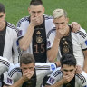 German players cover their mouths to protest against being gagged by FIFA.