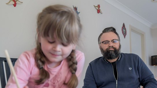 Disability worker David Wragg, at home with his daughter Elissa, has serious misgivings about the quality of her remote education. 