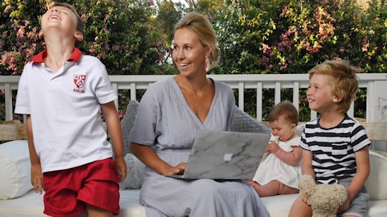 Lija Wilson working at home with children Jack (left), Harry (right) and baby Evie.