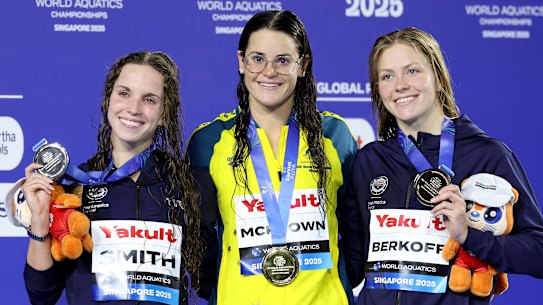 From left: Silver medalist Regan Smith of Team United States, Gold medalist Kaylee McKeown of Team Australia and Bronze medalist Katharine Berkoff of Team United States pose on the podium during the Women’s 100m Backstroke medal ceremony.