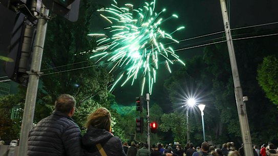 Crowds watch the New Year’s Eve fireworks at Treasury Gardens.