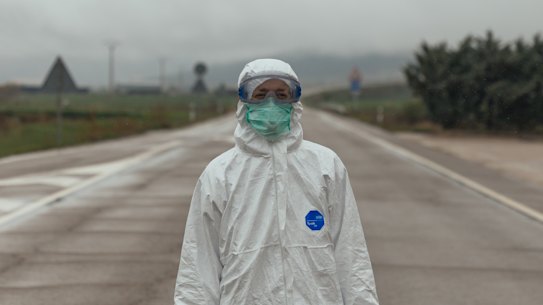 A Spanish Red Cross worker waits to transfer coronavirus patients to a nursing home in Huesca.