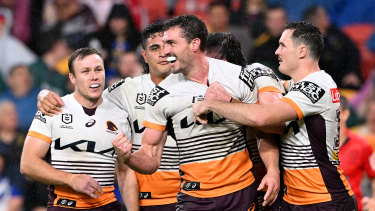 The Broncos celebrate one of Corey Oates’ two tries.