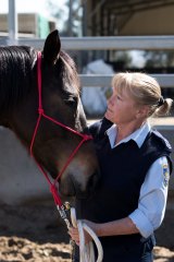 A retired racing horse with guard Janelle Bowden.