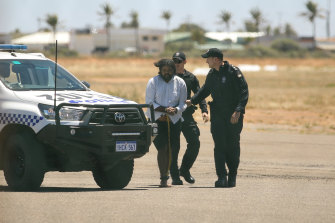 Terence Darrell Kelly boards a plane in Carnarvon on Friday.