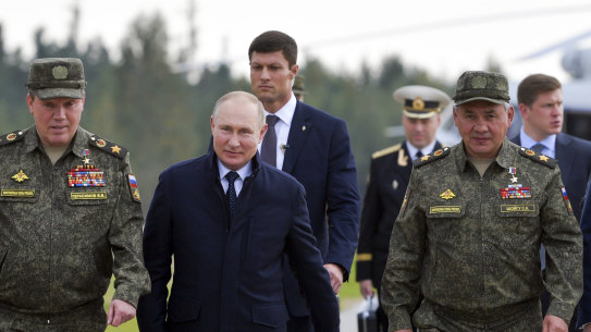 Russian President Vladimir Putin, centre, Russian Defence Minister Sergei Shoigu, right, and Russian General Staff Valery Gerasimov, left, walk to attend the joint strategic  Belarus Zapad-2021 exercise in the Nizhny Novgorod region of Russia.