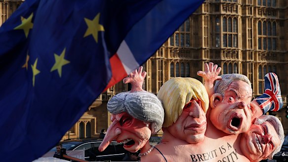 Flags fly above an anti-Brexit sculpture outside the Houses of Parliament in London.
