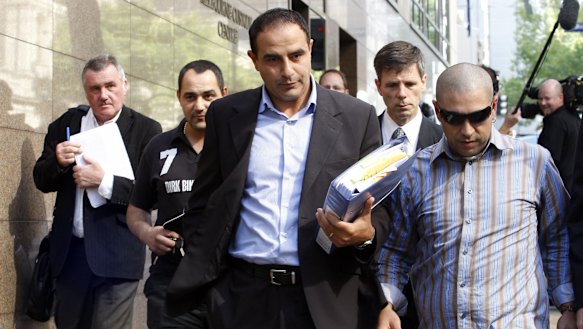 Rob Karam, centre, leaves the Melbourne Magistrates Court  in March 2009.