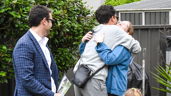 The winning pair embrace.