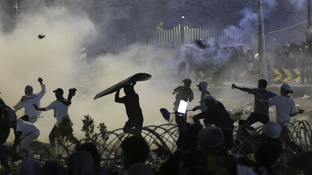 Rocks, riot shields and tear gas: central Jakarta on Wednesday night.