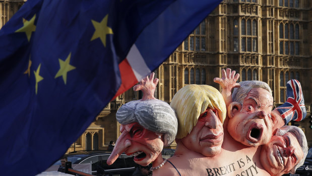 Flags fly above an anti-Brexit sculpture outside the Houses of Parliament in London.