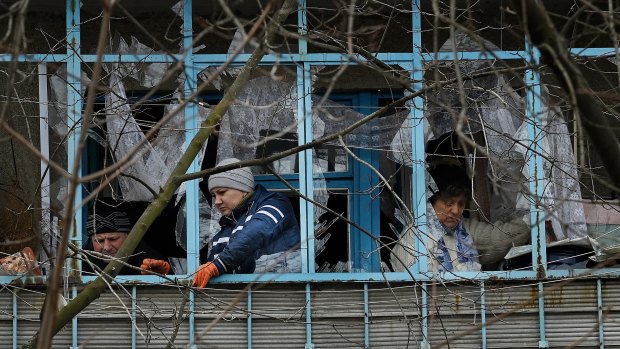 Residents clean up the damage from a missile attack on Kramatorsk.