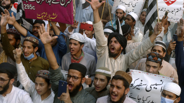 People chant during a protest in Pakistan against French President Emmanuel Macron and the republishing of caricatures of the Prophet Muhammad.