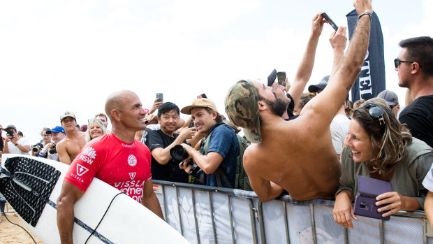 Always got time for his fans: Slater poses for selfies after winning his heat. 